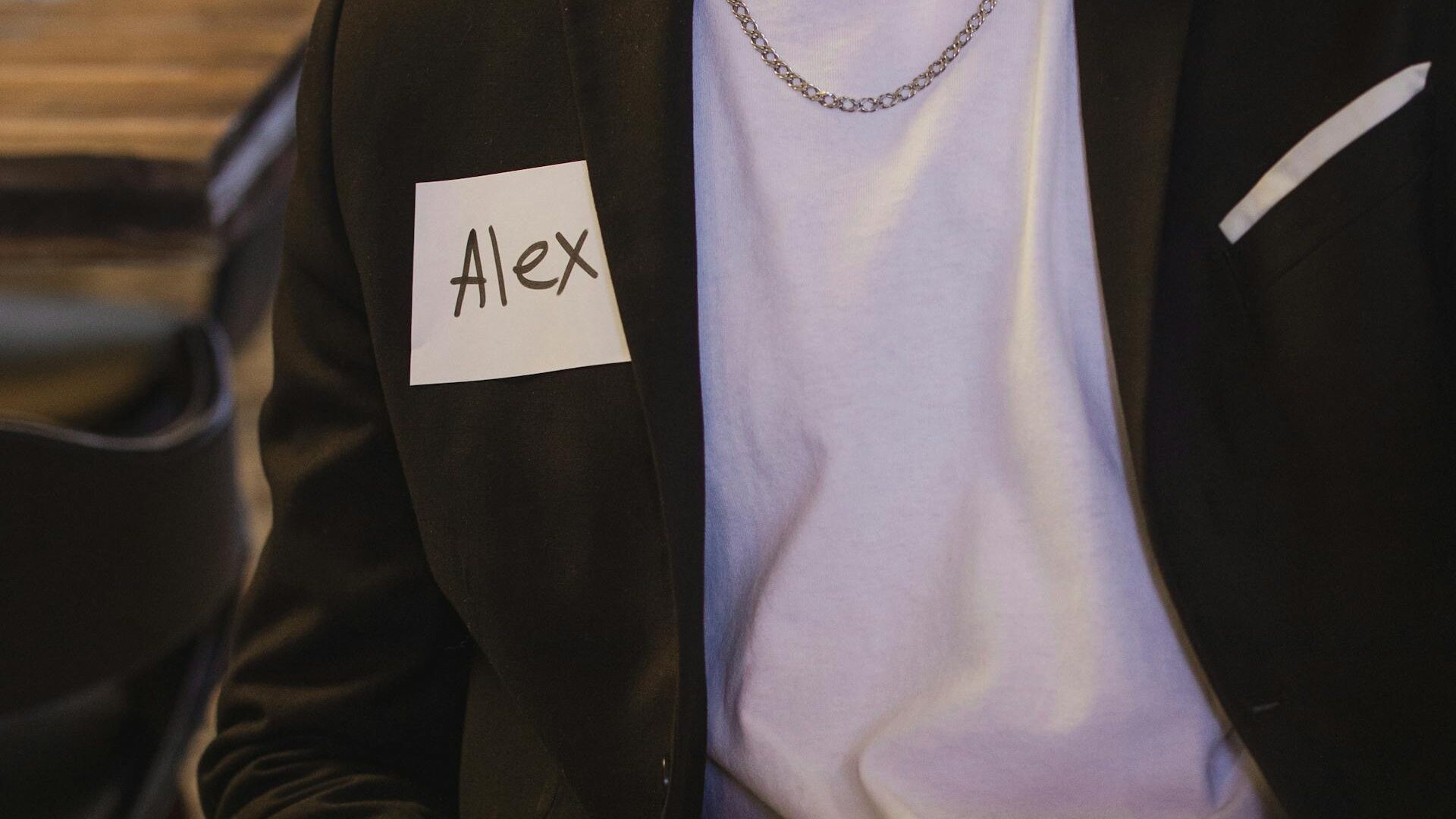 a person with a label with 'Alex' written on it showing personalization